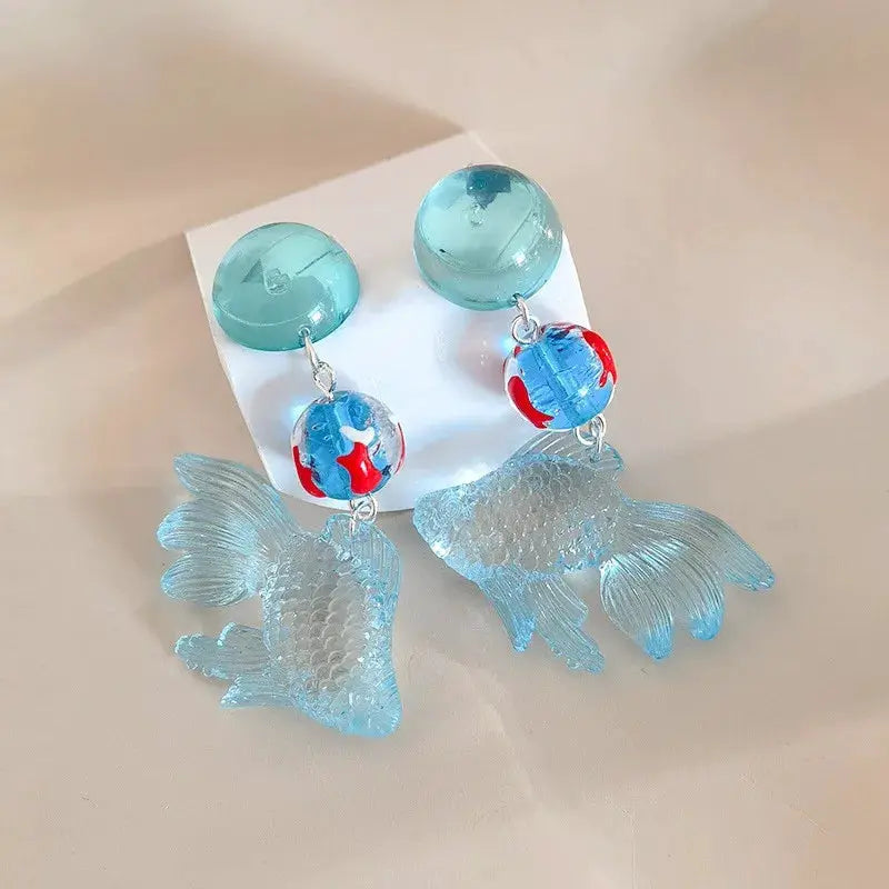 Koi fish drop earrings pair; translucent teal round studs with blue koi pendants