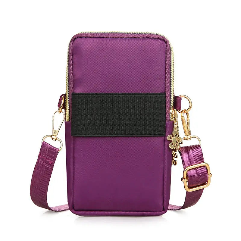 Mobile phone bag, purple crossbody with black front pocket and gold hardware, adjustable strap