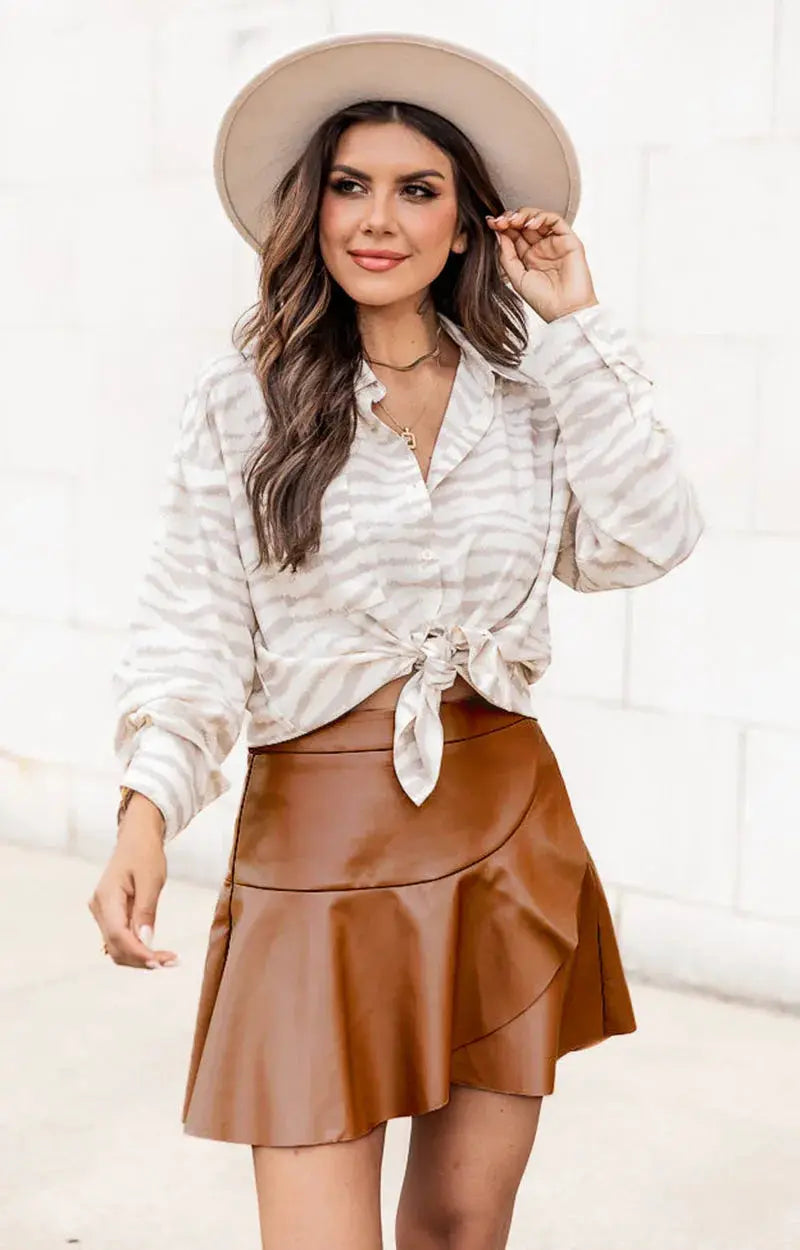 Women faux leather mini skirt by Simples Market in tan brown with high waist and wrap-panel design