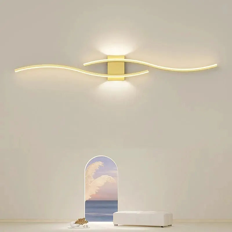 Moder LED Wall Lamp Long Strip by Simples Market in gold finish with curved light strips, warm ambient lighting.