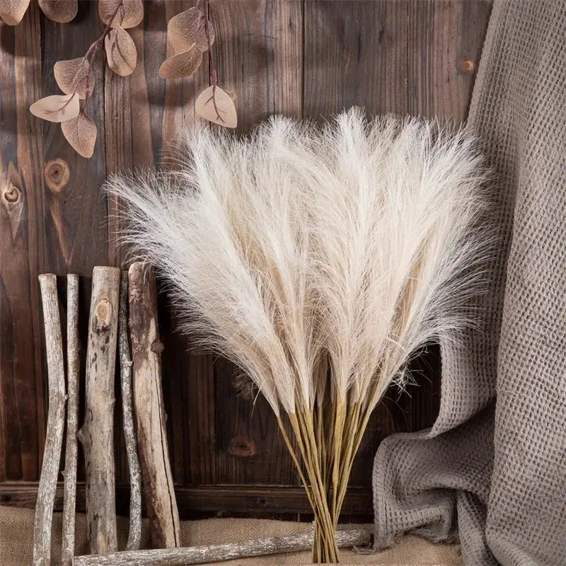 Artificial pampas grass bouquet, cream fluffy plumes with tied stems for bohemian home decor.