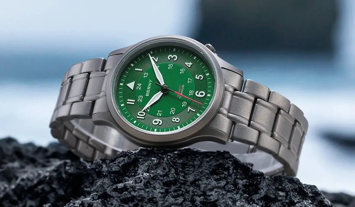 BERNY full titanium men's field watch with green dial, luminous hands, metal link bracelet.