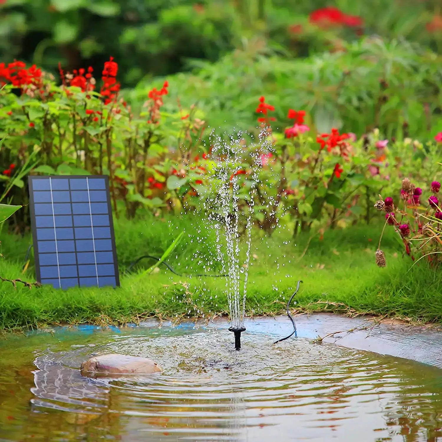 Solar fountain pump kit by Simples Market with 6 nozzles, low-noise spray in a garden pond beside a solar panel