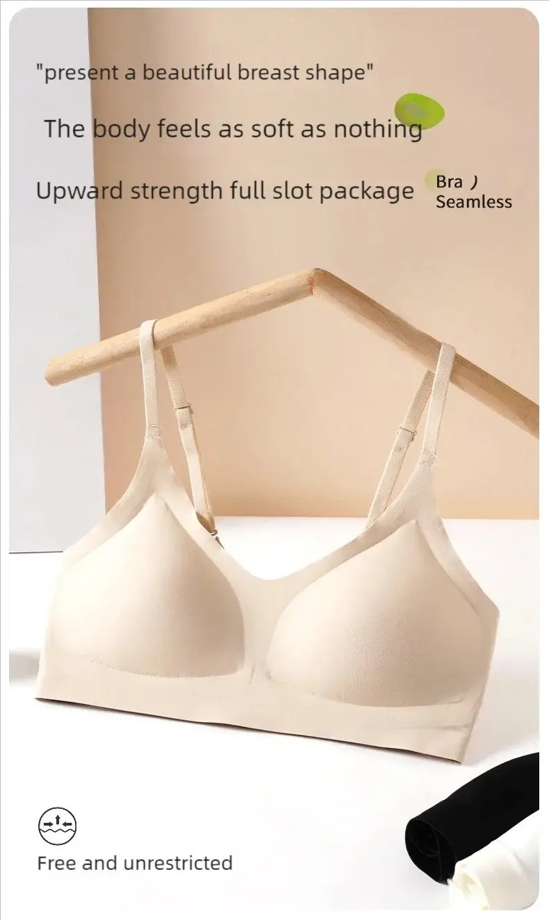 Beige seamless bra with molded cups and adjustable straps, displayed on a wooden hanger