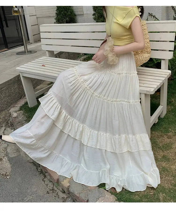 White tiered ruffle-hem maxi skirt; high-waisted, flowy chiffon layers by Simples Market