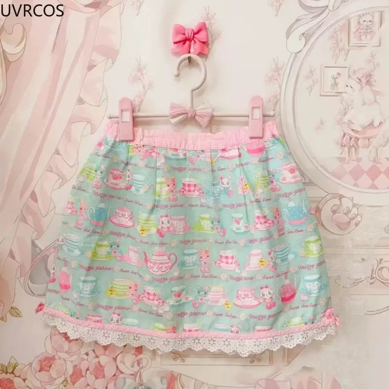 Sweet Lolita style cake mini skirt in pastel mint with pink waistband, bow trim and lace hem