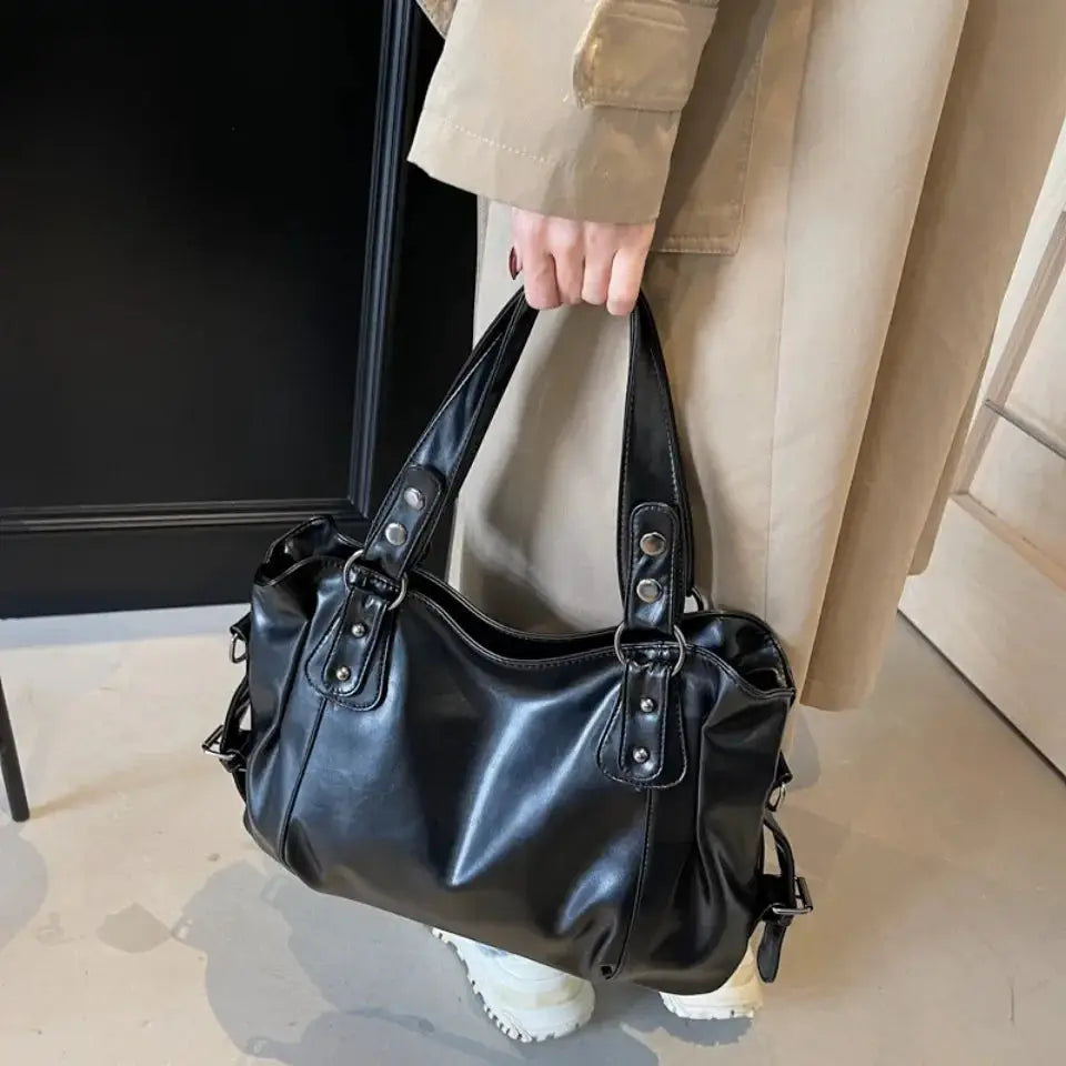 Roomy black PU leather shoulder bag with double handles and silver hardware, large-capacity tote.