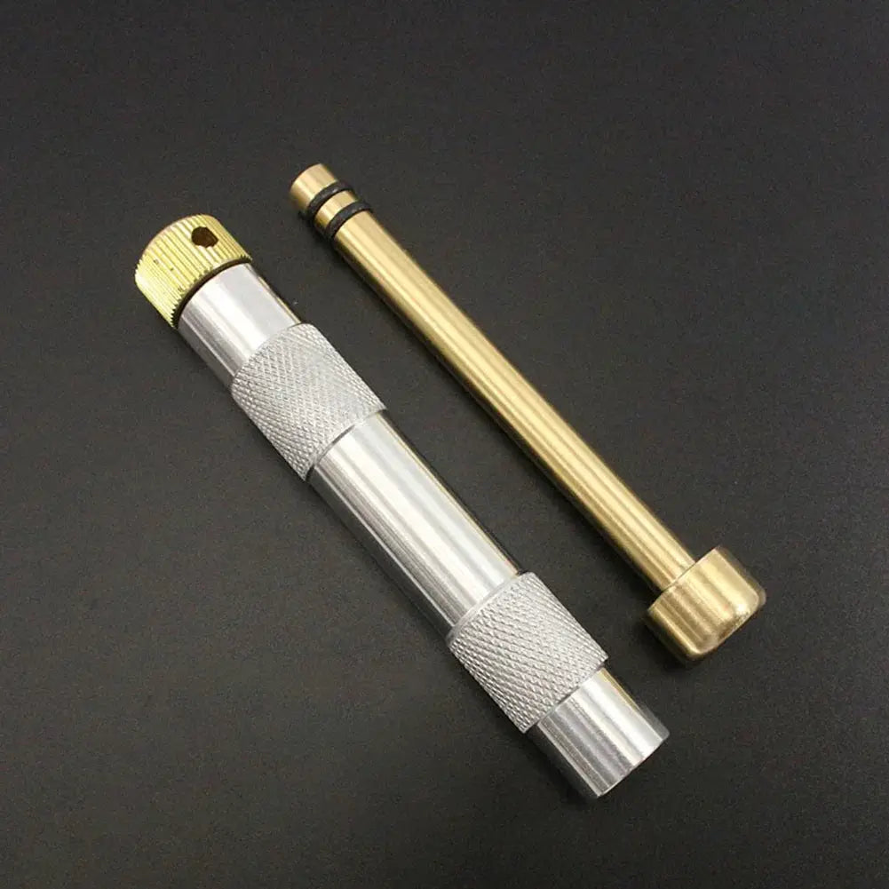 Simples Market brass emergency fire tube with compression igniter; silver knurled grip and gold end cap