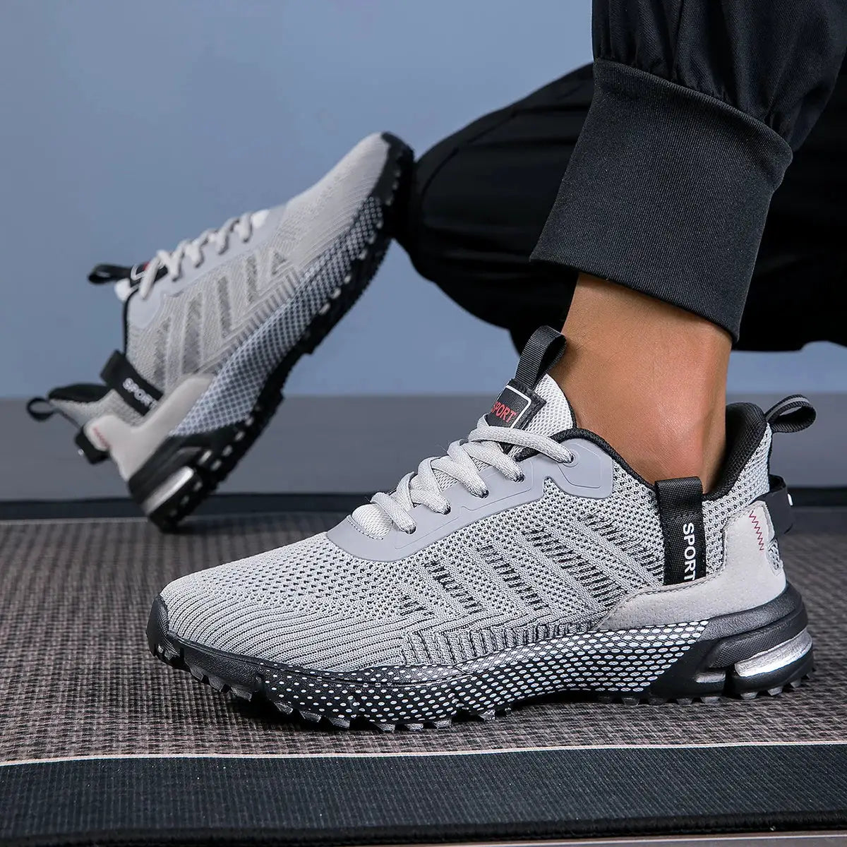 Men's running shoes, pair with lightweight breathable grey knit upper, lace-up and non-slip outsole.