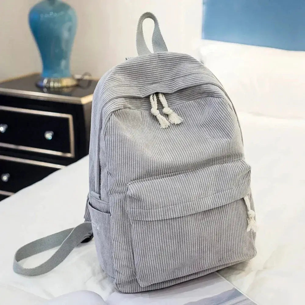 Gray corduroy student backpack with front pocket and top handle, unisex campus bag