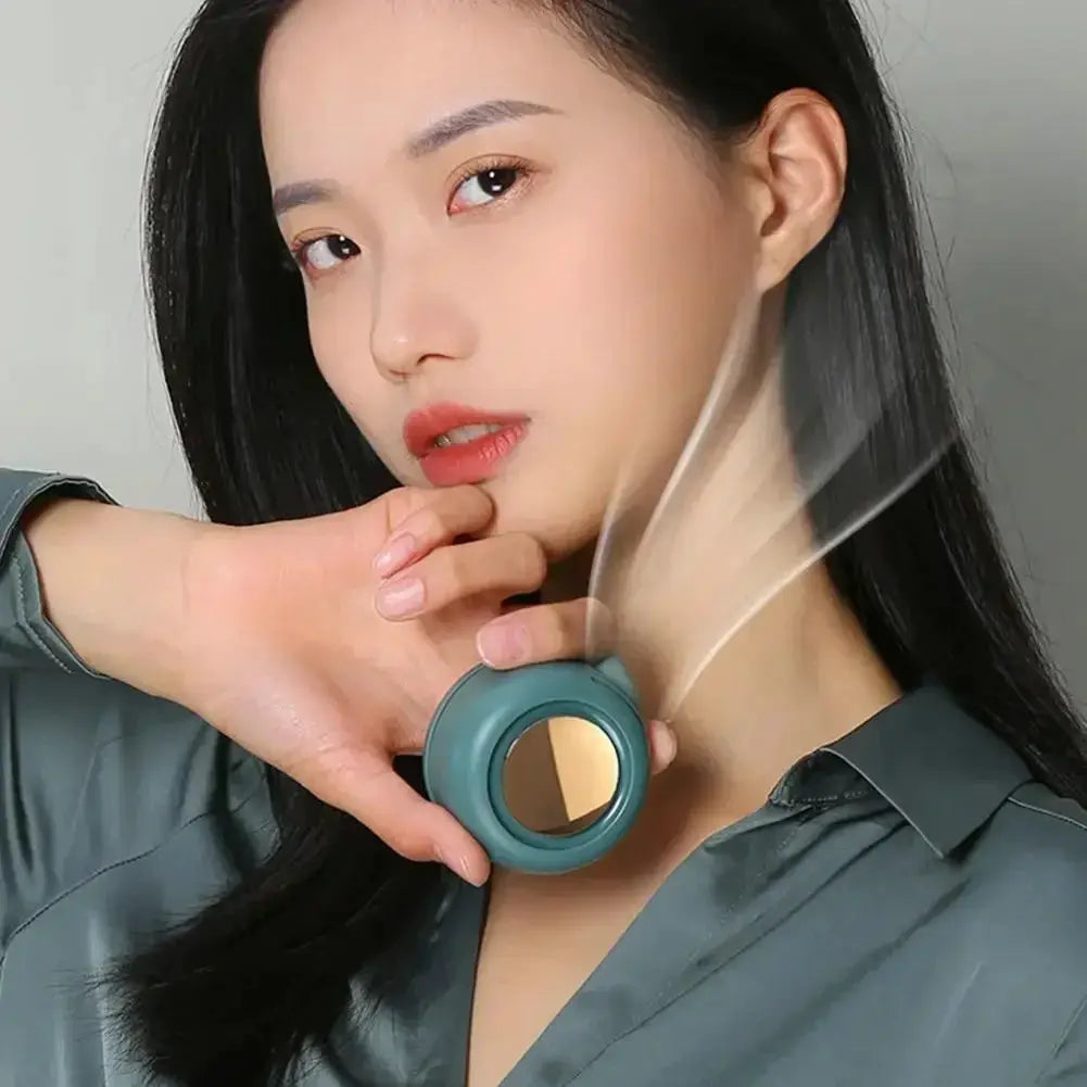 Portable bladeless clip-on fan, teal circular body with a gold center for cooling.