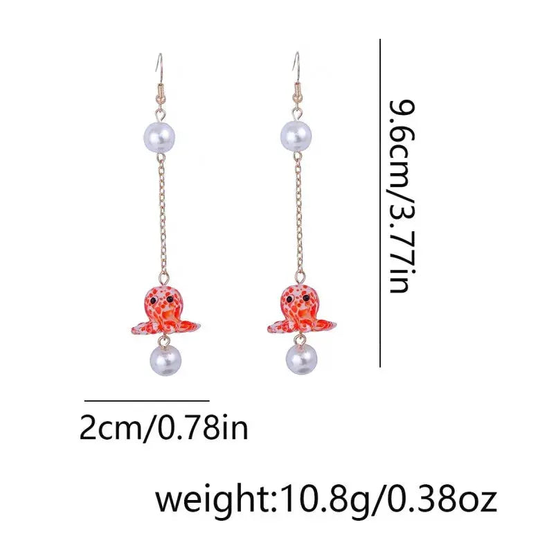 Octopus earrings pair with glass orange-red octopus charms, pearl beads, and gold-tone long-drop chains.