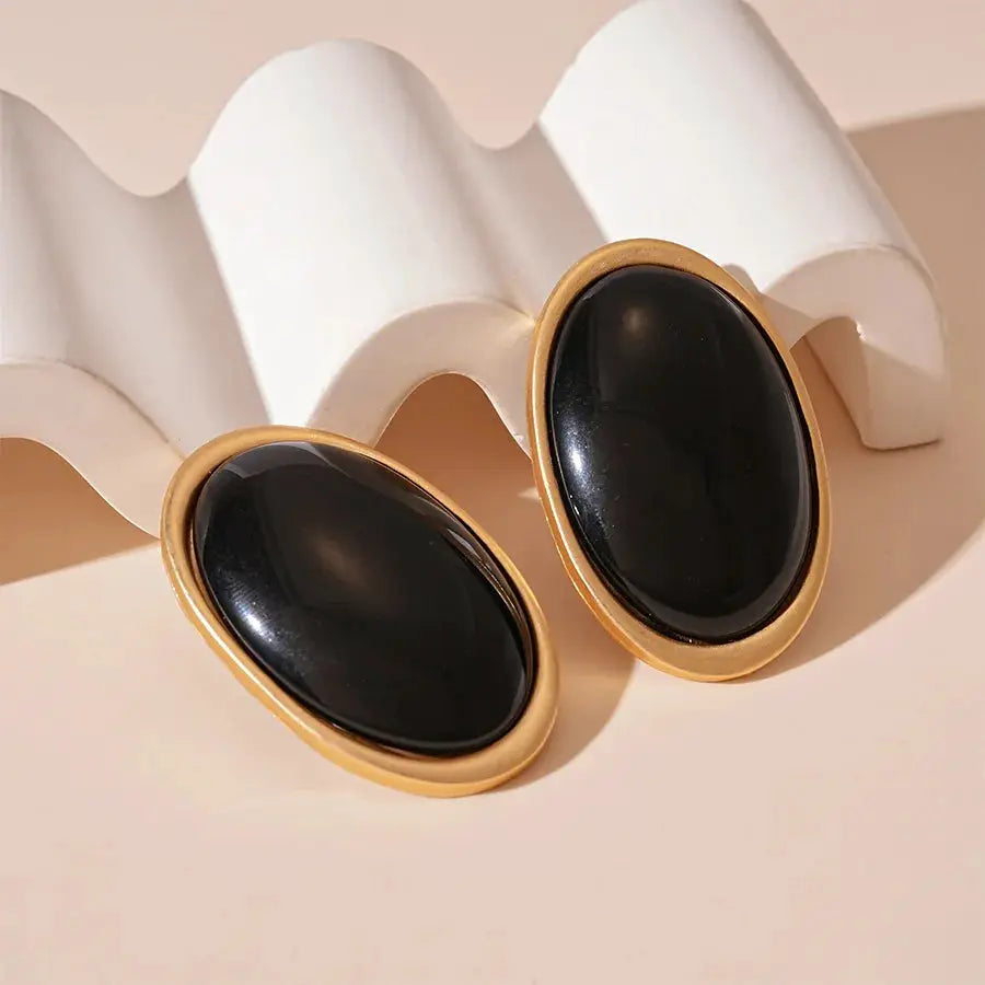 Oval black stone earrings with gold-tone bezel; vintage-style women's studs