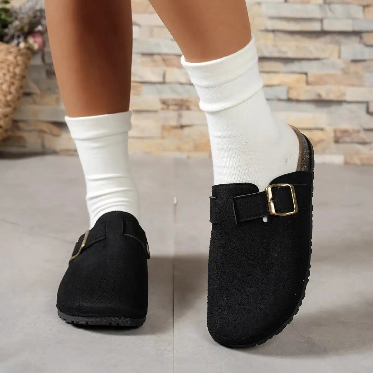 Pair of black suede flats with buckled strap for women, casual chic footwear