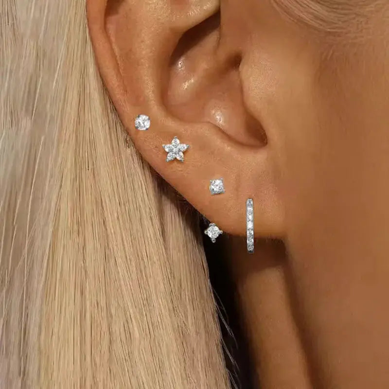 Simples Market 4pc zircon earring set on ear: round CZ stud, star-shaped flower stud, square stud, vertical bar hoop.