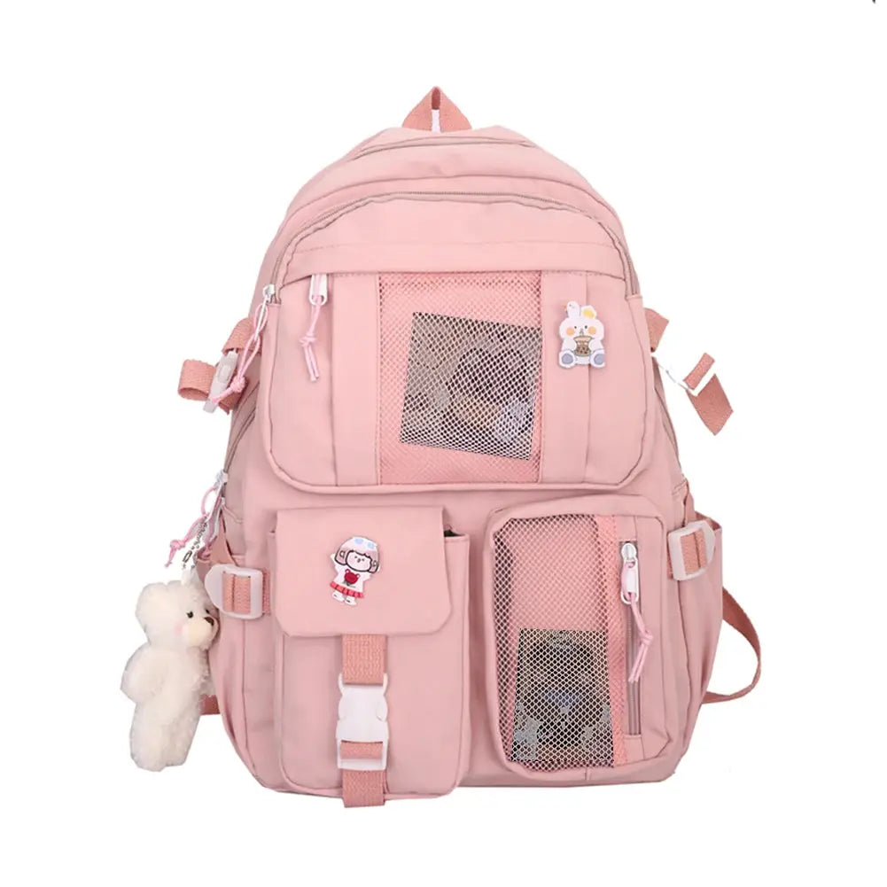 Simples Market pink school backpack with multiple pockets, mesh panels, and a teddy bear keychain.