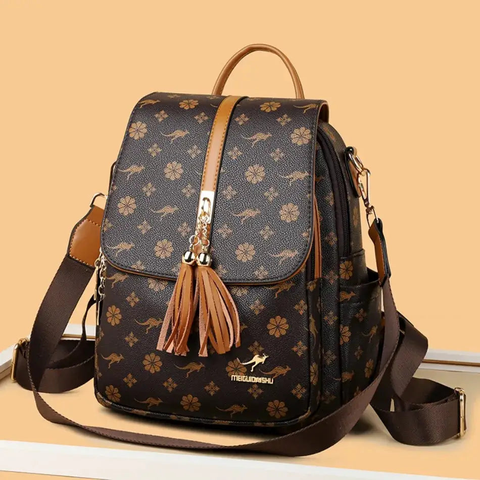 Ladies backpack by Simples Market; brown leather-look bag with tassel charm and floral print