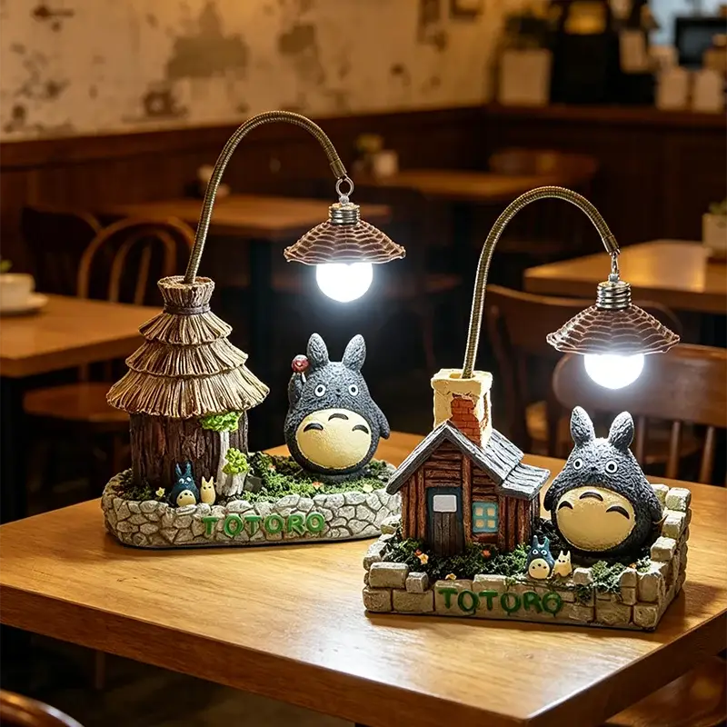 Two Totoro LED desk lamps with cozy cottage bases and warm bulbs on a wooden table