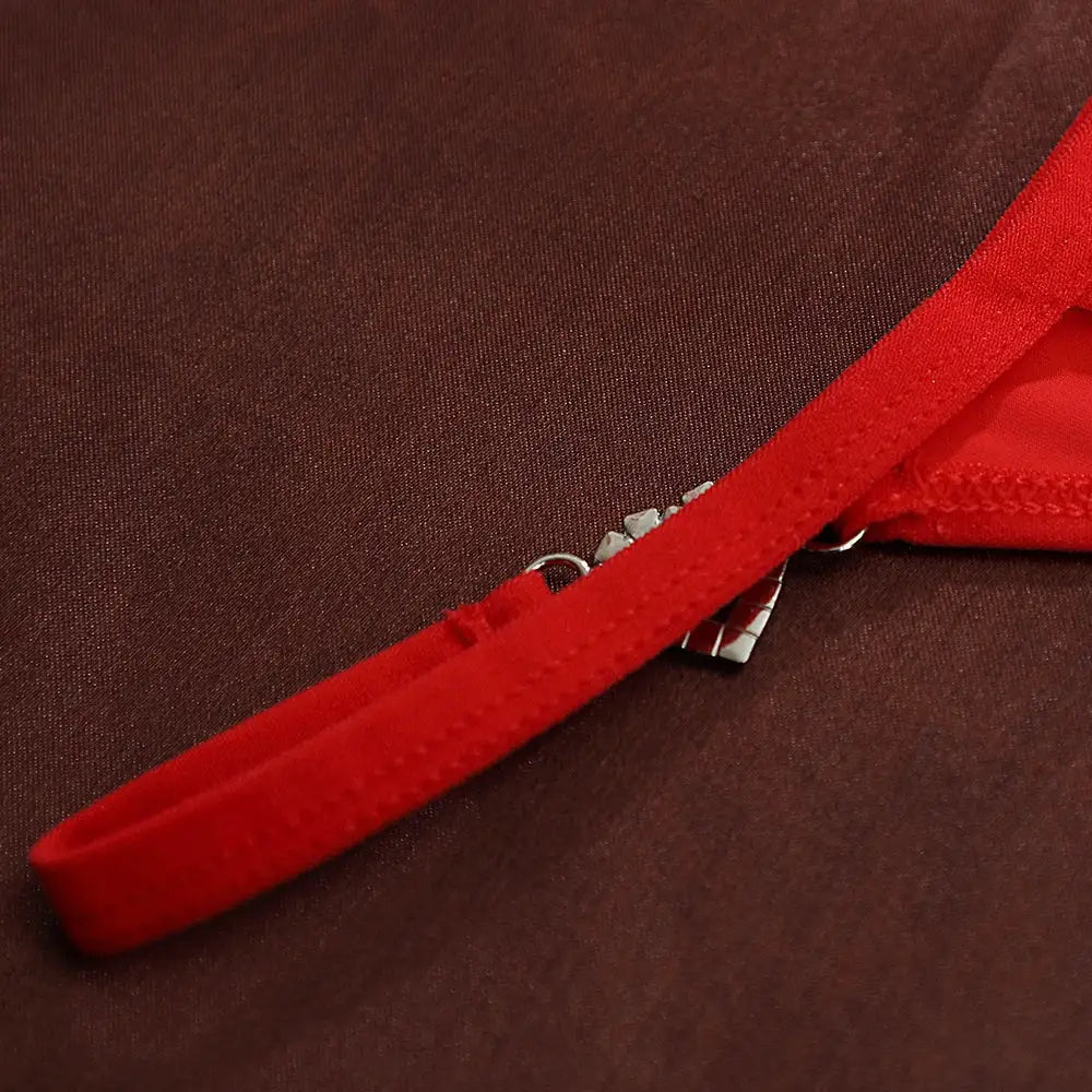 Red women's low-rise thong with heart decoration and cotton fabric.