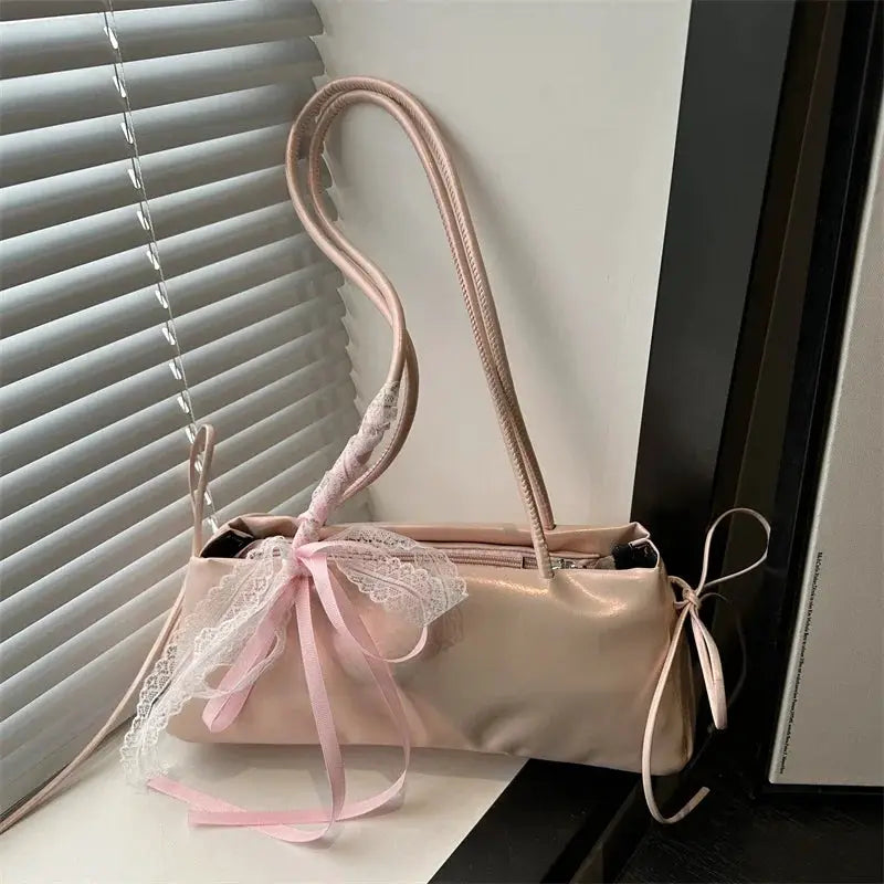 Pink PU square shoulder bag with lace bow detail and ballet-style top handle.