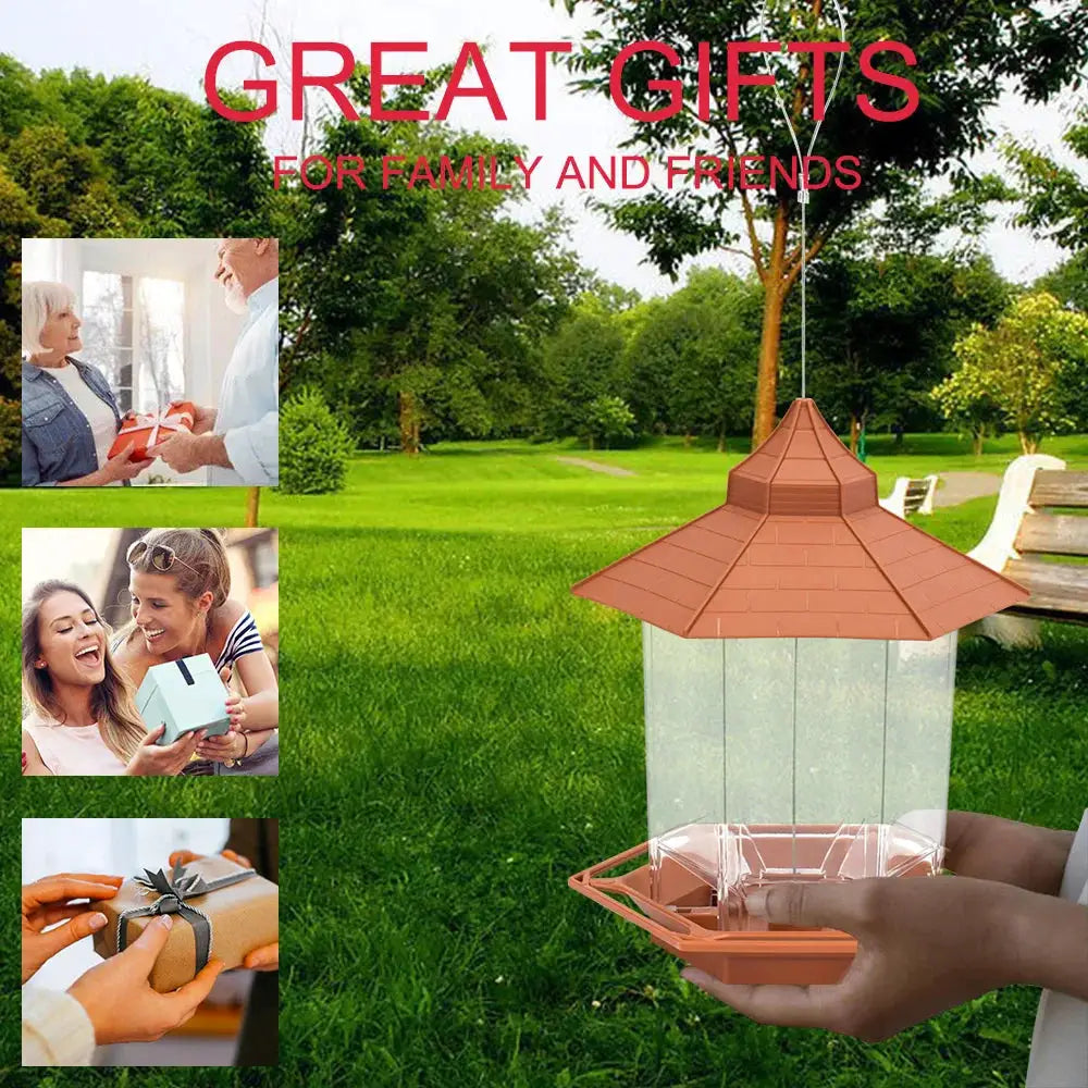 Automatic bird feeder hanging from a cord with peach gazebo roof and clear plastic container for outdoor feeding.