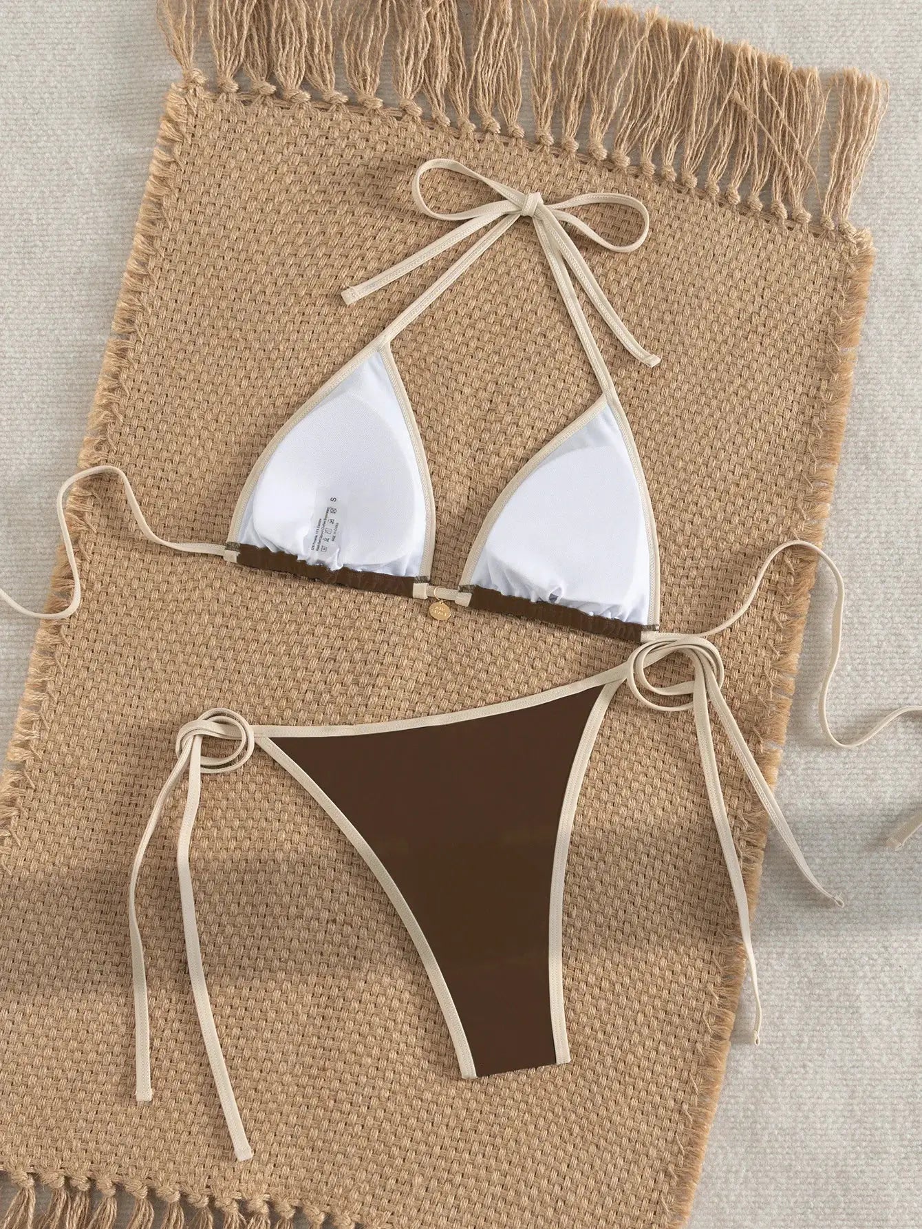 Bikini set: white triangle top with beige edging and halter ties, brown color-block bottom with white trim.