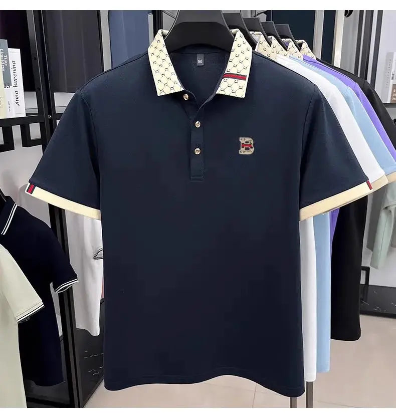 Men's polo shirt by Simples Market, navy with beige patterned collar and cuffs, B emblem on chest.