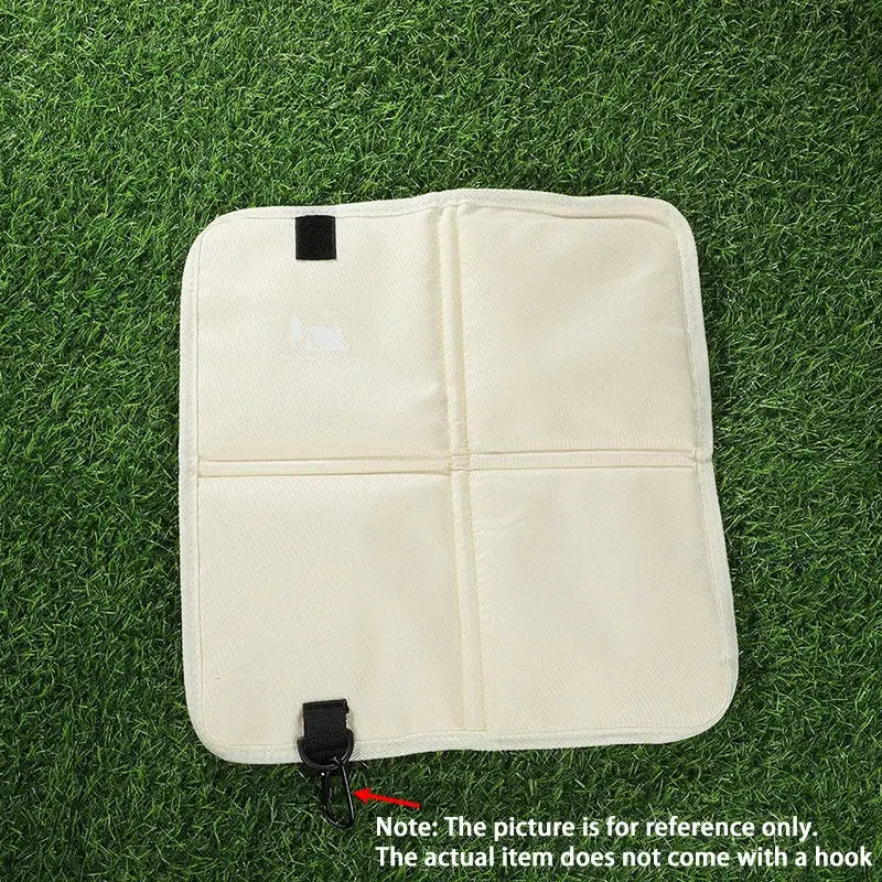 Outdoor camping foldable seat cushion in beige moisture-proof fabric with four-quadrant fold and black strap fasteners