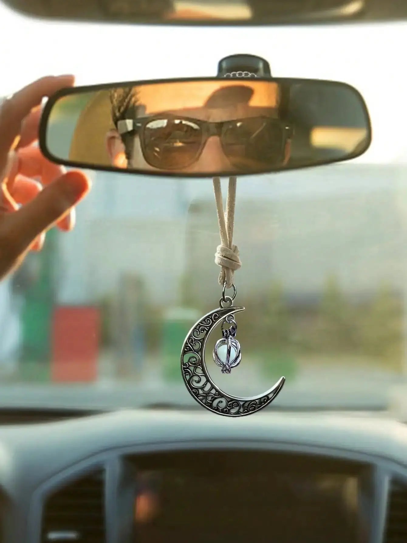 Luminous Moon Pendant car ornament with hollow crescent design and luminous stone inlay