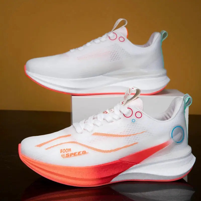 Pair of white marathon running shoes with orange gradient soles and teal heel loops.