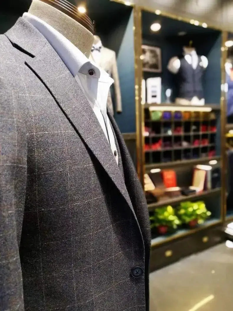 Men's gray plaid blazer on a mannequin with a white oxford shirt in a showroom display
