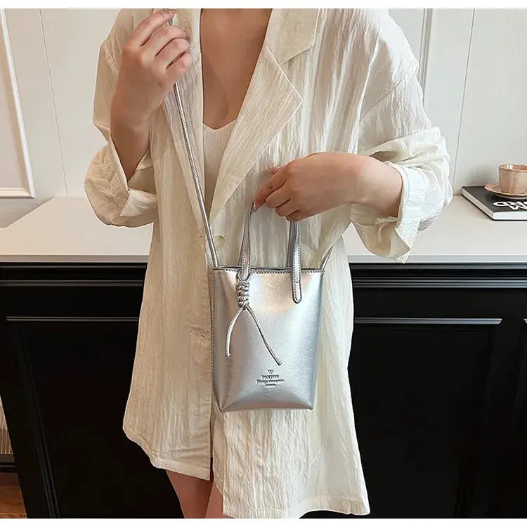 PU leather mini crossbody bag in metallic silver with knotted front detail and long slim strap