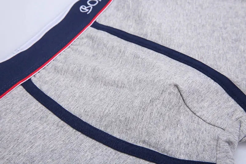 Boxer shorts in gray cotton with navy trim and red-white waistband.