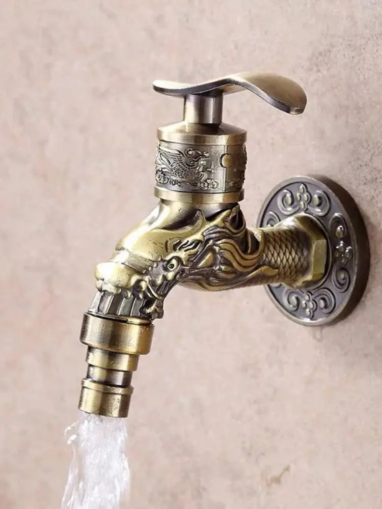 Outdoor faucet with dragon motif, wall-mounted brass-finish zinc alloy spigot.