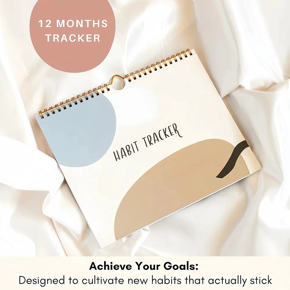 Habit tracker calendar journal with rose-gold spiral binding, beige cover and abstract blue and beige shapes