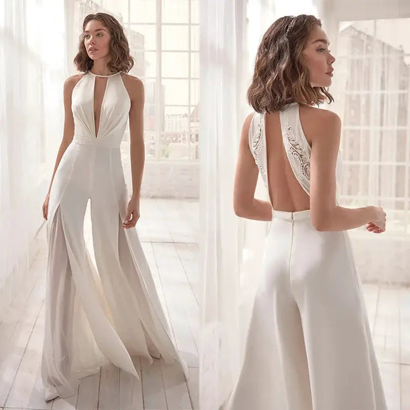 White sleeveless jumpsuit with halter-neck deep-V, backless lace panels, and wide-leg flared pants