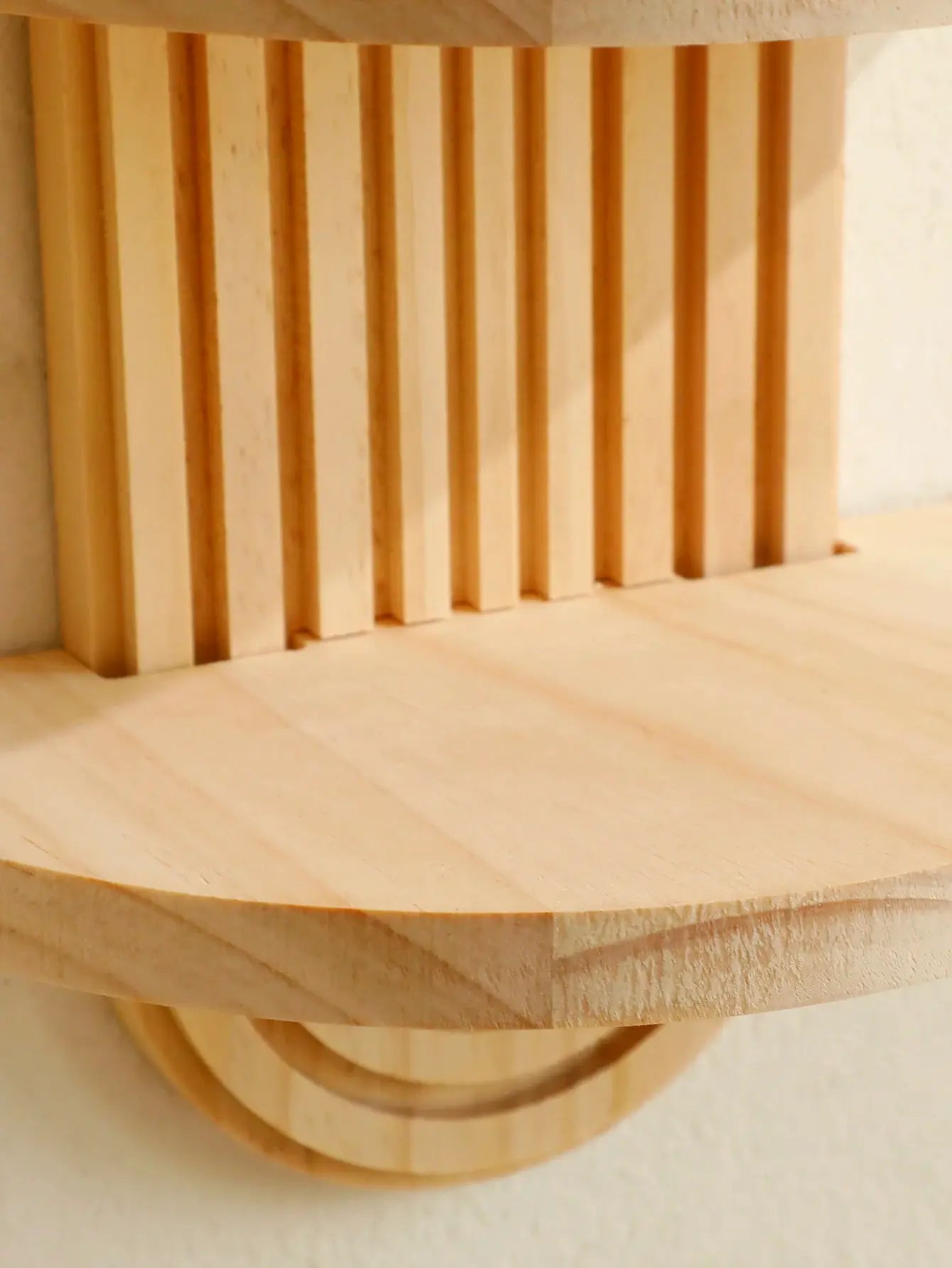 Boho-style wooden wall shelf with geometric vertical slats in natural wood finish