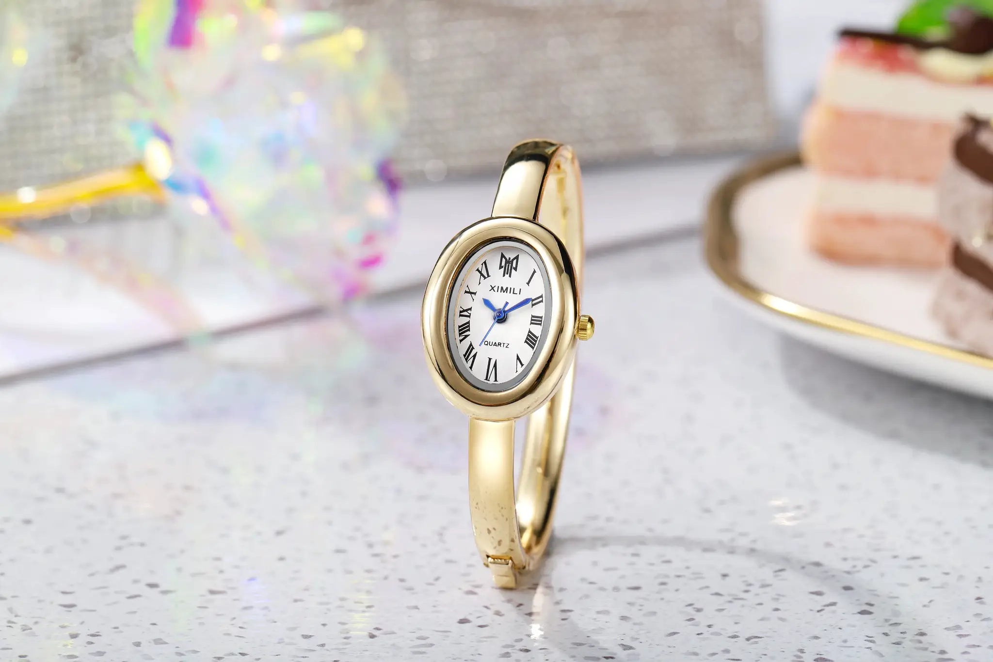 Gold-tone women's dress watch with oval dial and Roman numerals, XIMILI