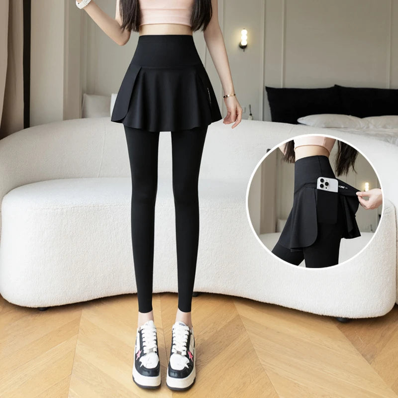 Women's black high-waist seamless leggings with faux skirt overlay and built-in phone pocket, yoga pants