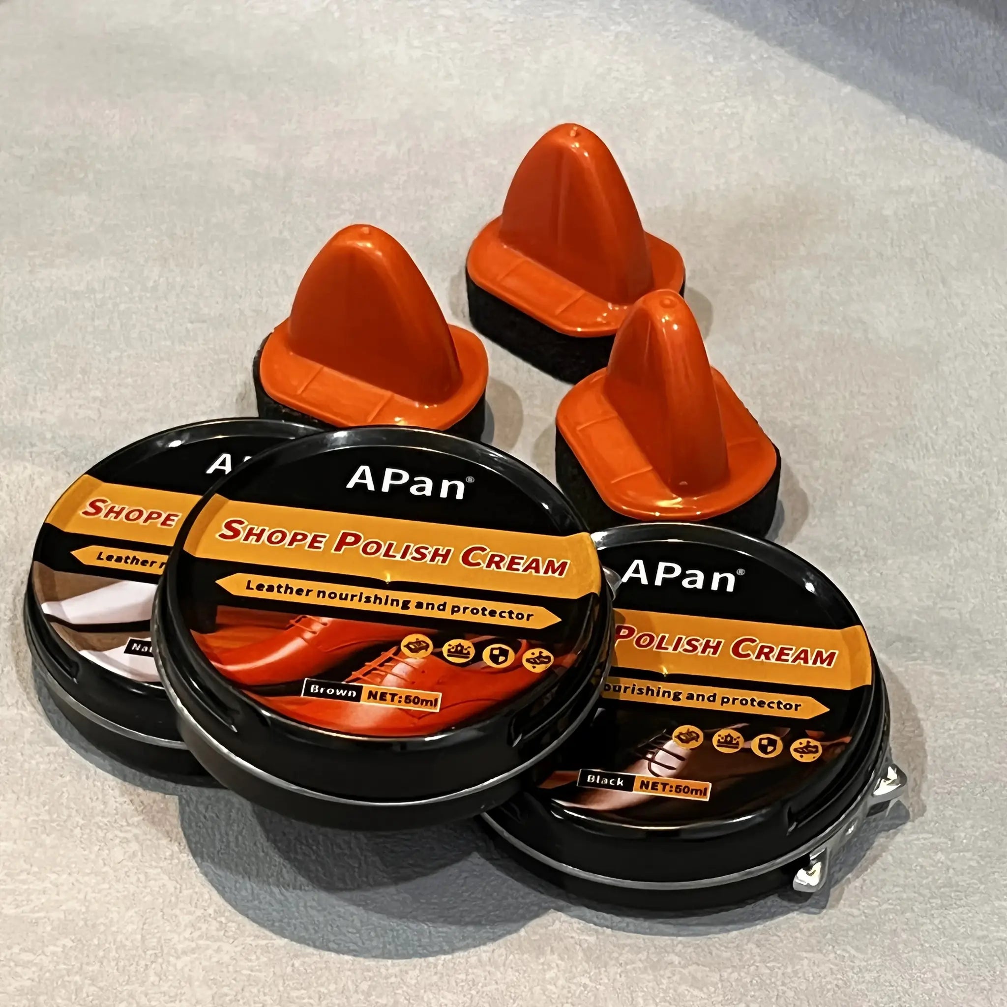 Faux leather shoe polishing kit with multiple APan polish cream jars and orange caps
