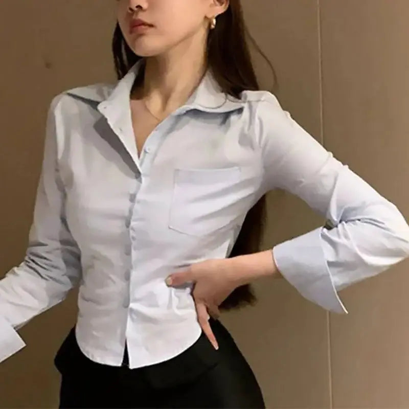 White chiffon office blouse with chest pocket, button-front, lapel collar, and long sleeves.