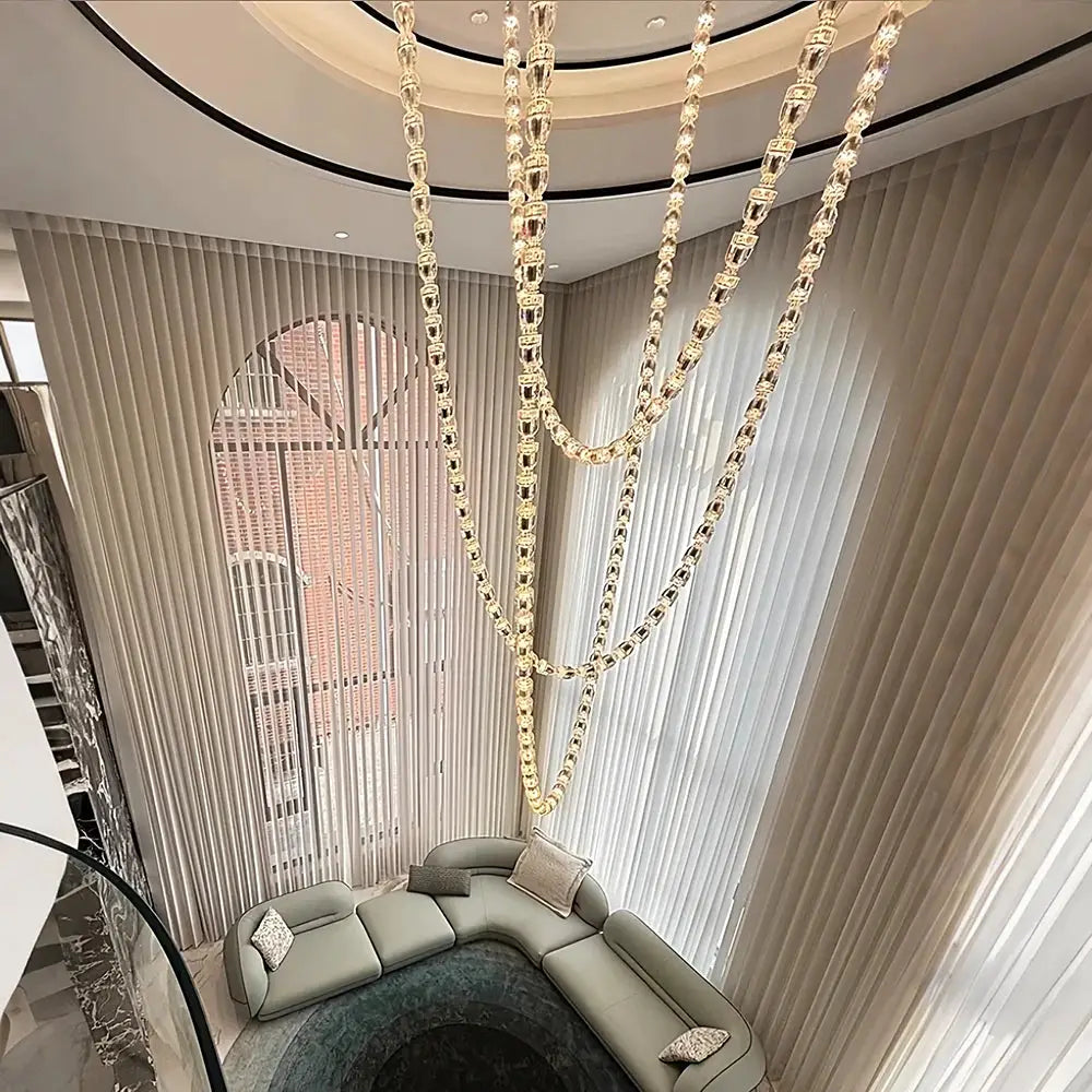 Chandelier ceiling light with multi-strand crystal acrylic bead chains, gold-tone, adjustable length over living room.