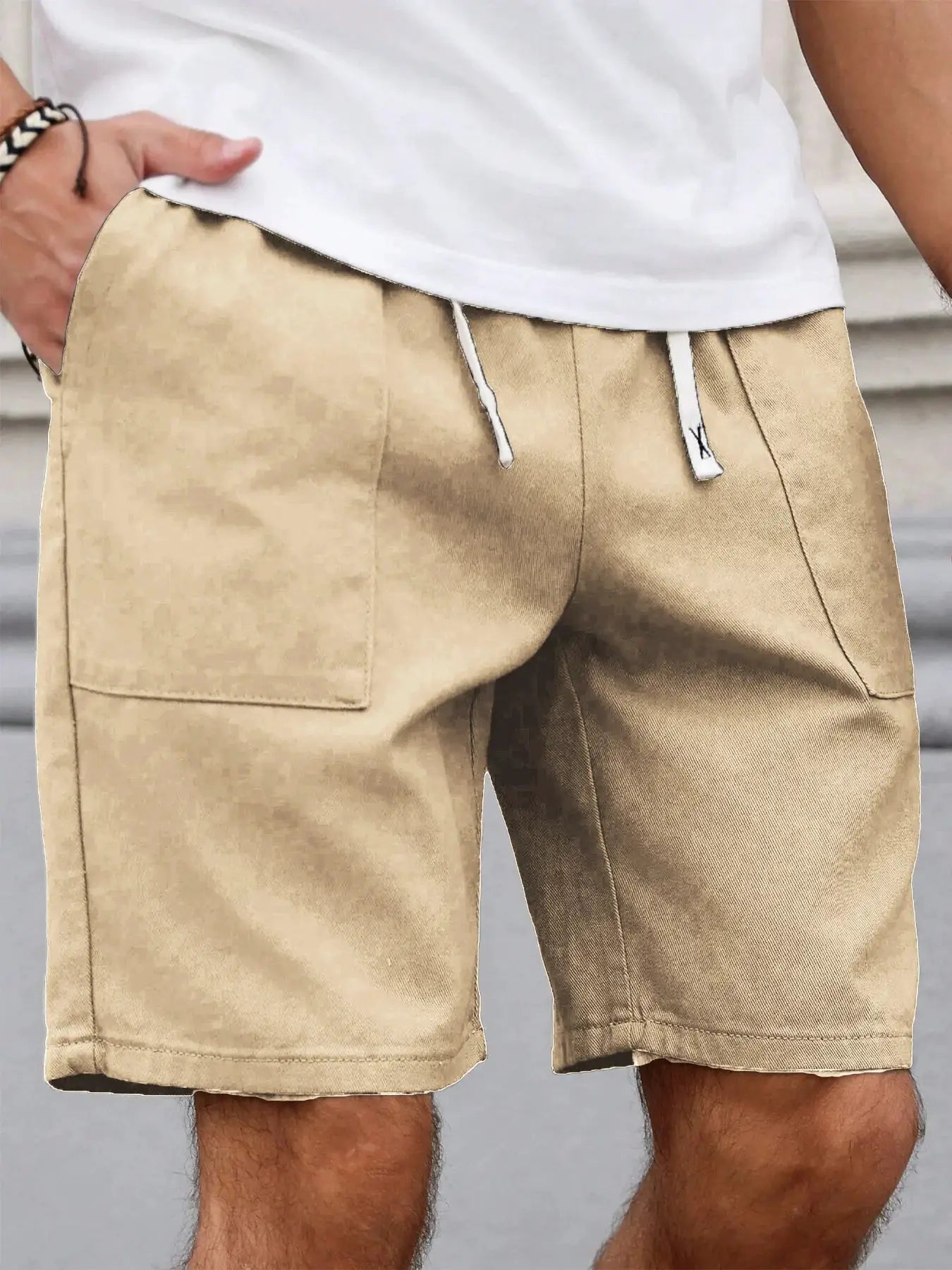 Beige men's mid-length shorts with white drawstring and cargo pocket.