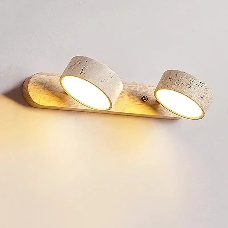 LED wall light with two round lamps on a wood backplate, warm white glow