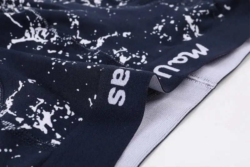 Men's navy cotton print boxers with white splatter pattern and light gray waistband.