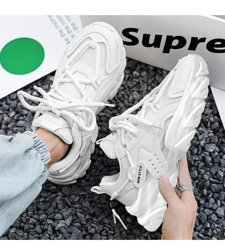 Men's white breathable sneakers with thick chunky sole; Supreme box backdrop.