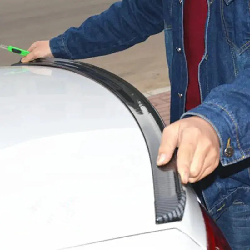 Universal 5D carbon fiber car spoiler being installed on a white car, DIY styling wing