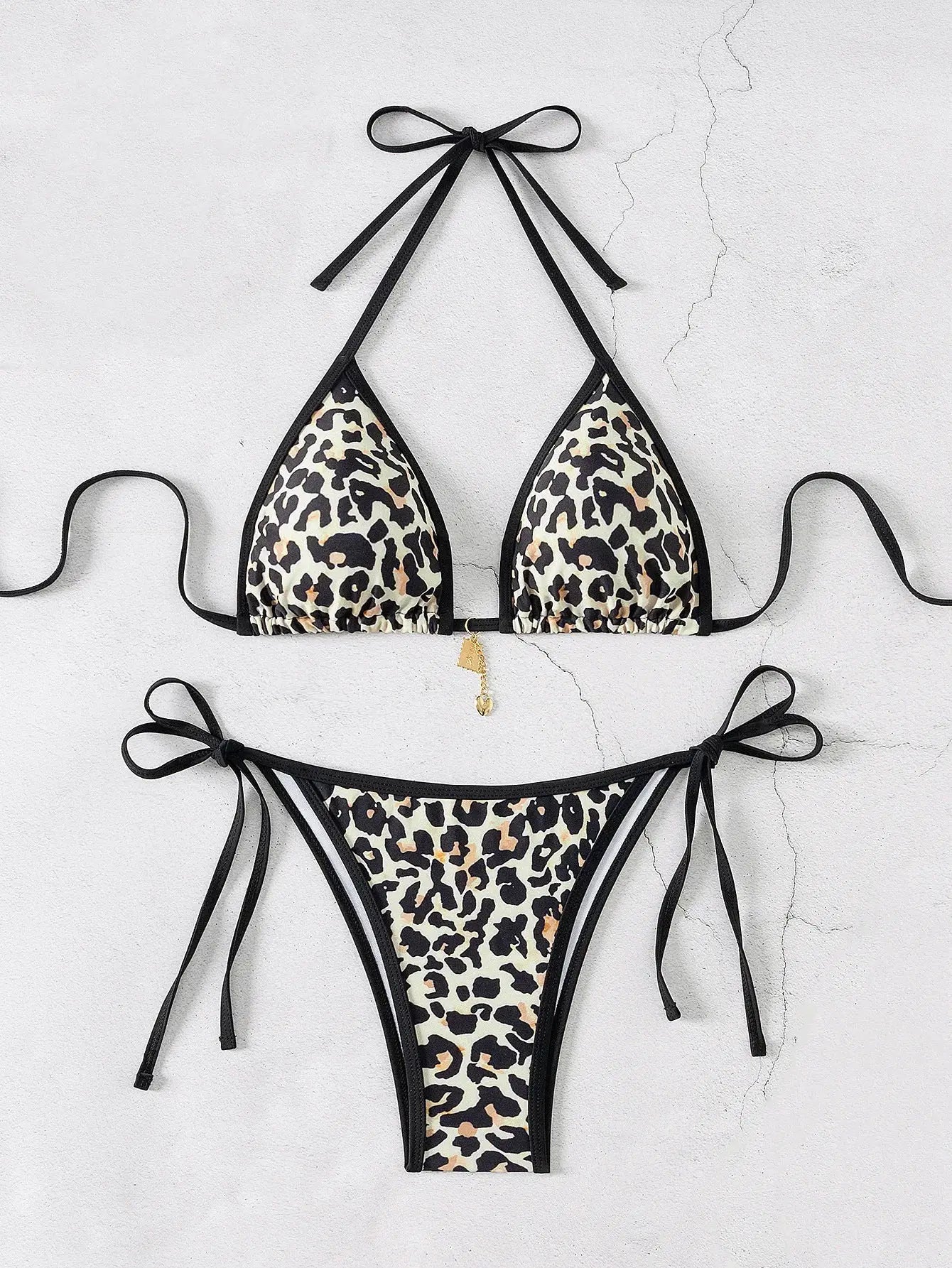 Simples Market triangle bikini set in leopard print with black trim and string ties; push-up top and Brazilian bottoms.