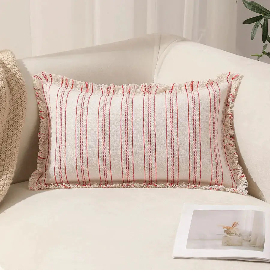Simples Market Summer Boho pillow cover 30x50 with red striped pattern and fringed edges on cream sofa.