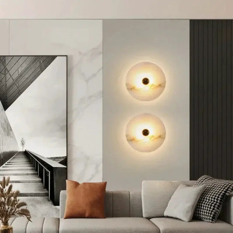 Luxury Spanish natural marble wall lamp pair in copper finish mounted on living room wall with warm ambient light